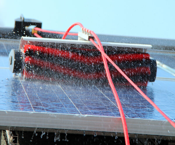 Cleaning solar panels Cleaning solar panels with brush and water.